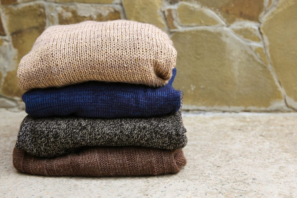 Three sweaters stacked on top of each other, perfect for cold weather golfing.