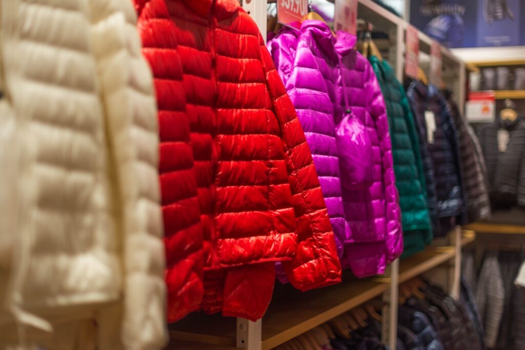 A row of colorful down jackets in a store, perfect for cold weather.