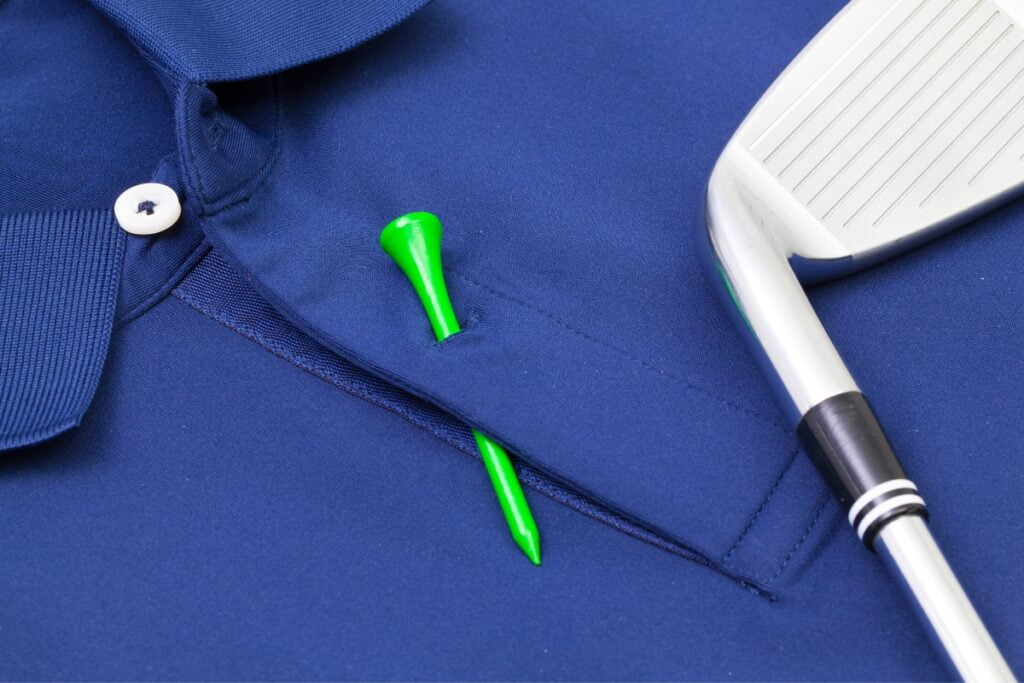 Golf technology club and green tee on a blue polo shirt.